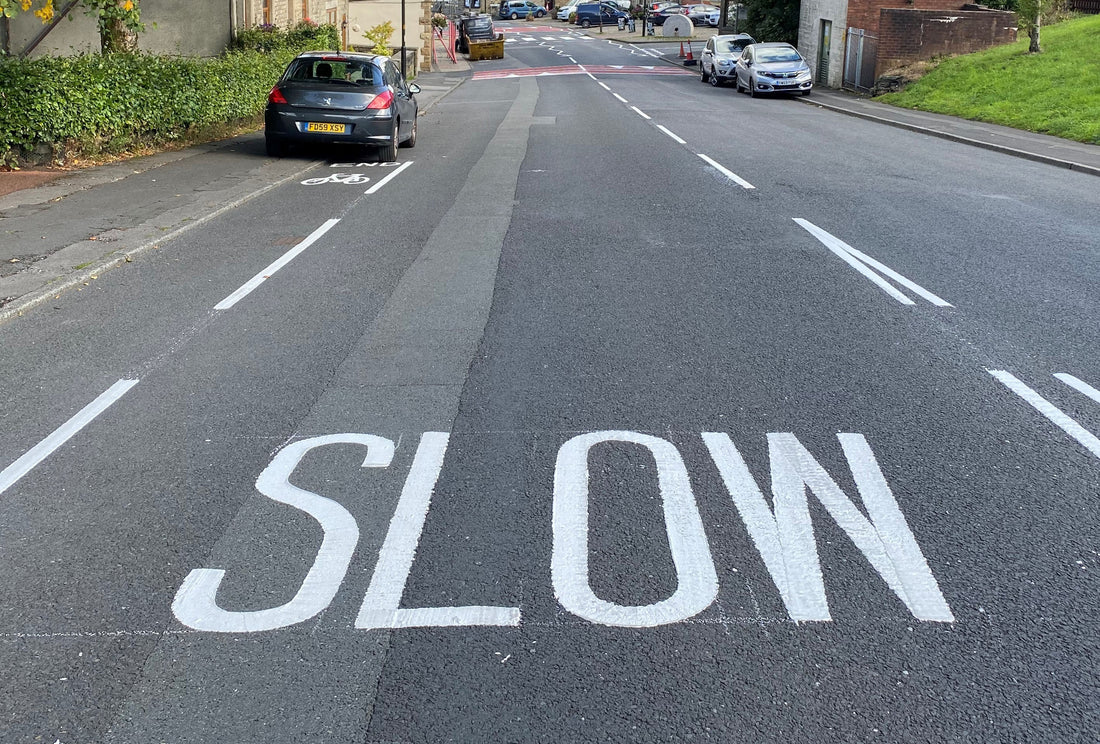 An image of a road with the words slow painted on it