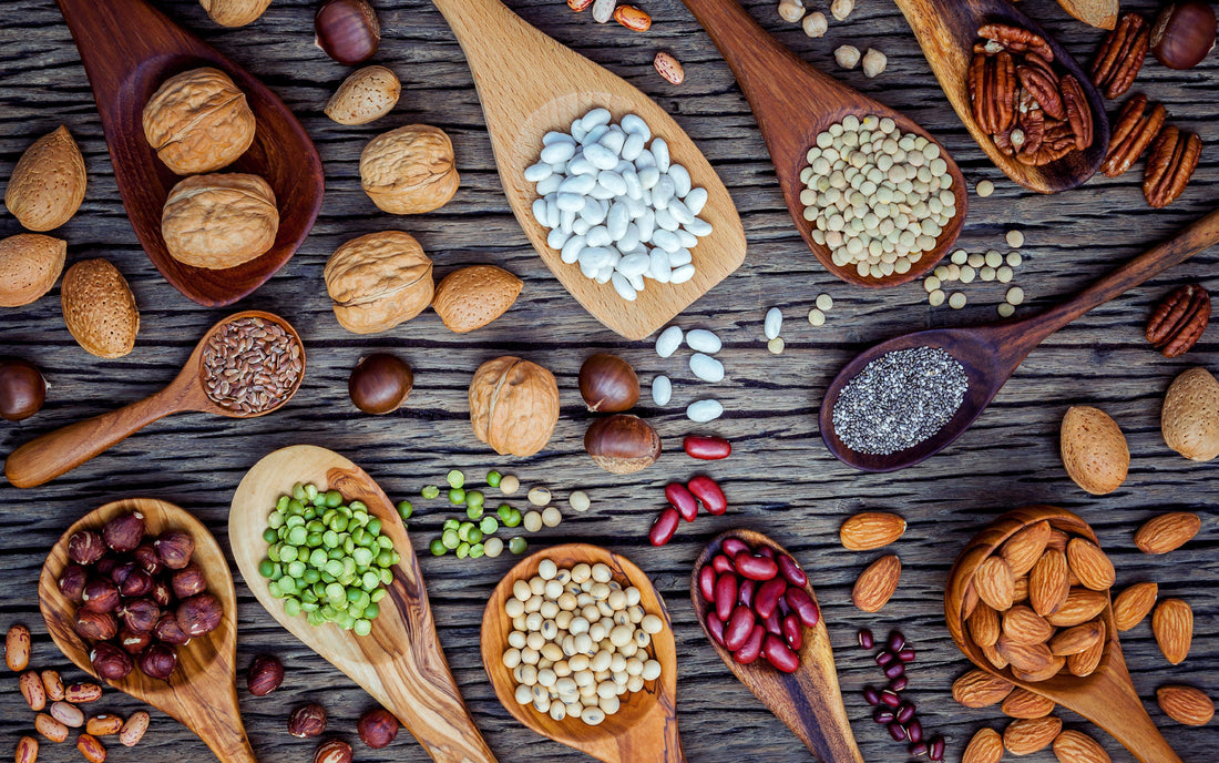 High Fibre foods displayed on a table such as nuts beean and pulses